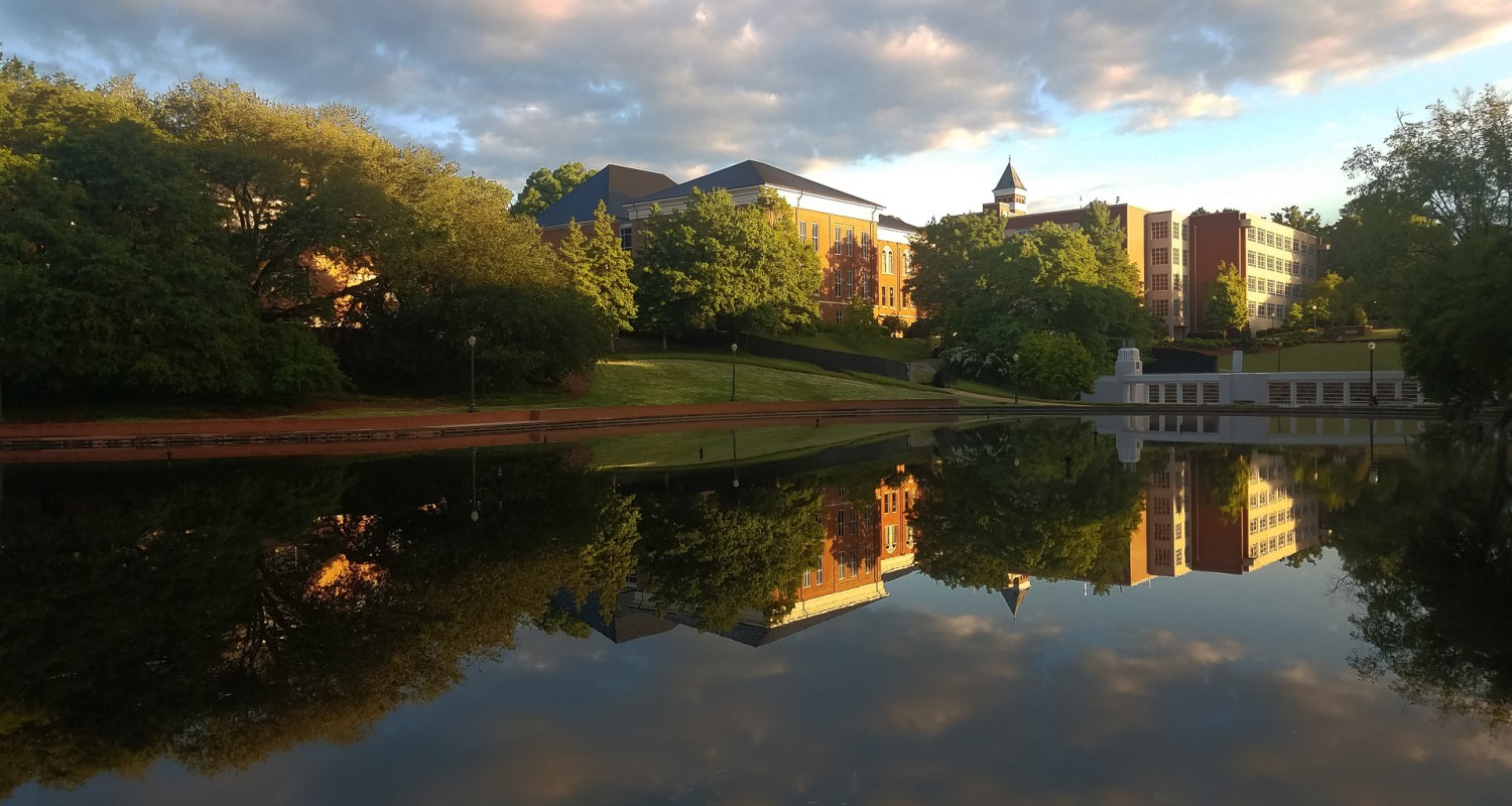 a body of water with buildings and trees