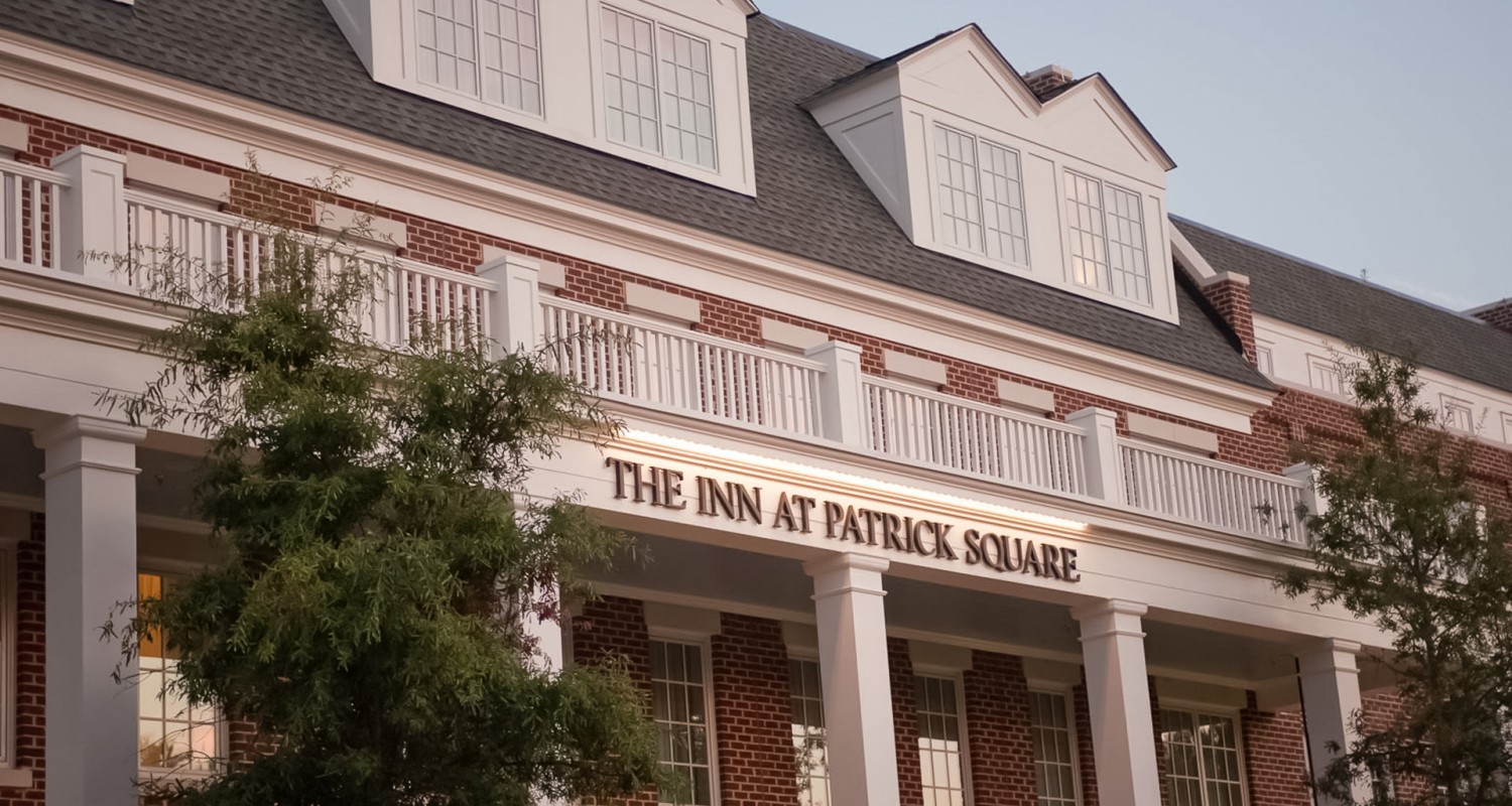 a building with a balcony and a tree