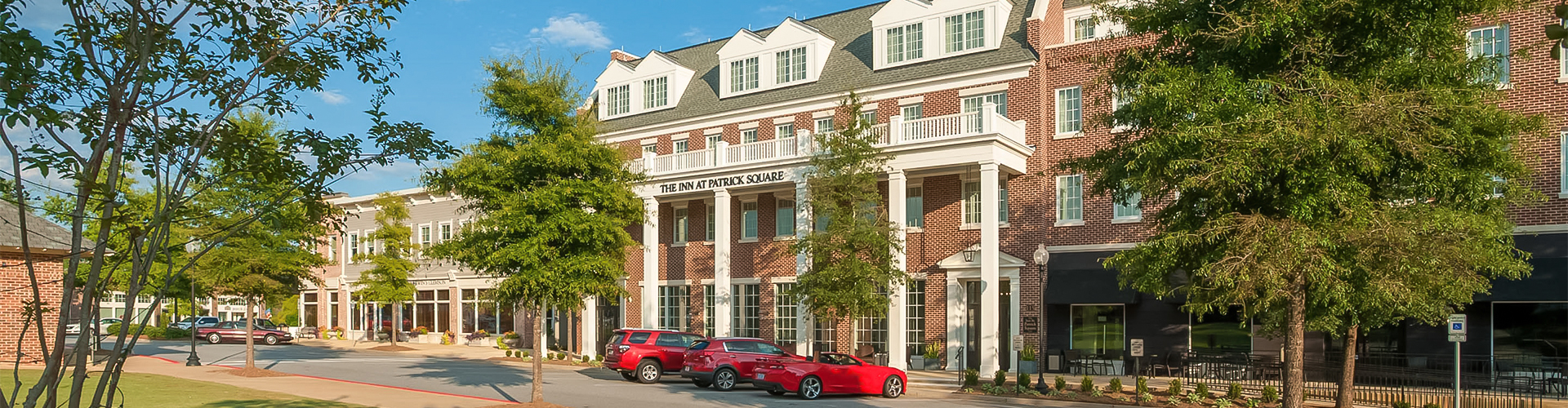 a red car parked in front of a building