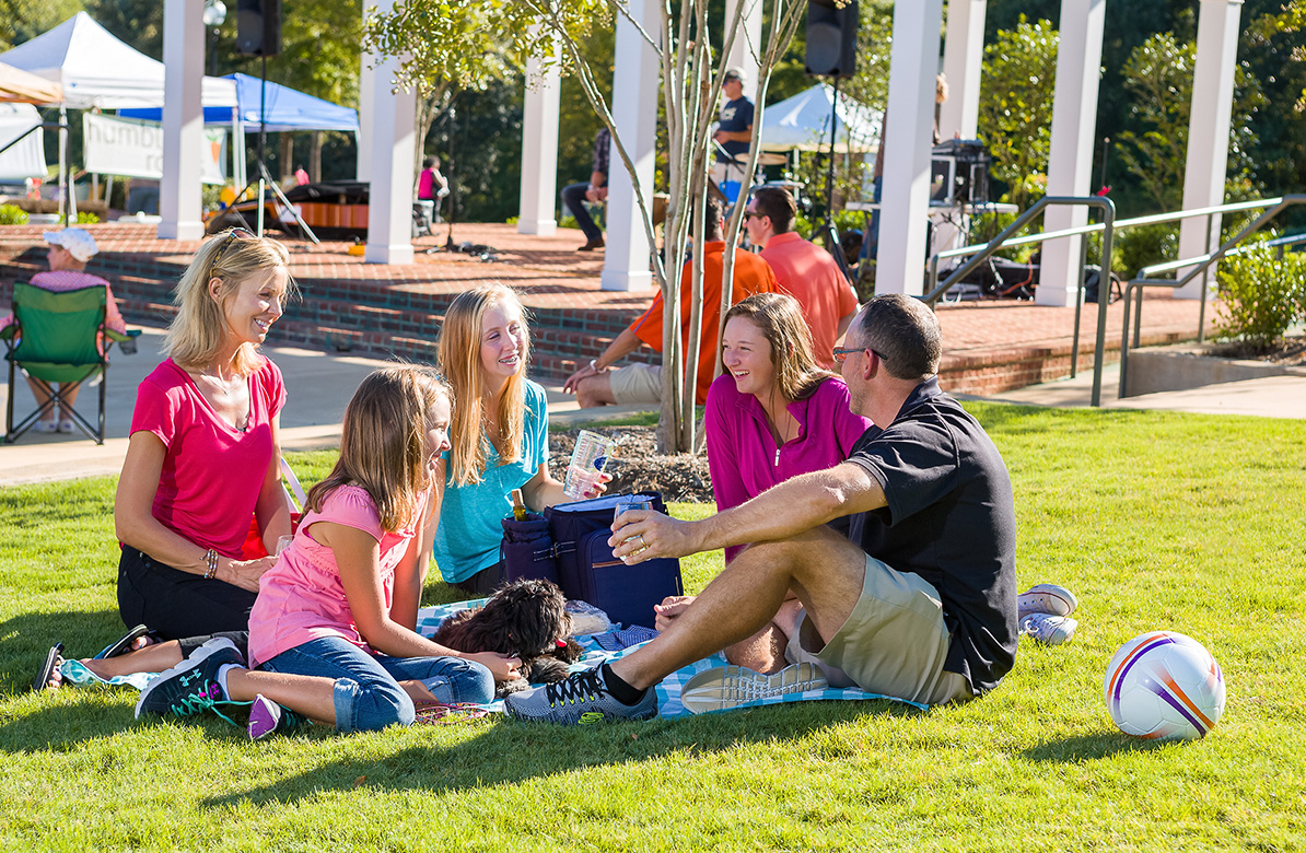 a group of people sitting on the grass