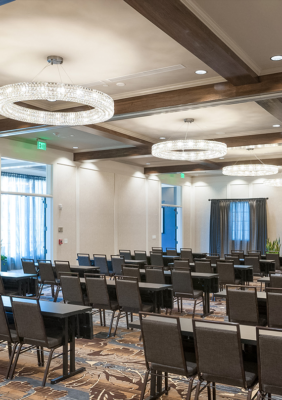 a room with chairs and chandeliers
