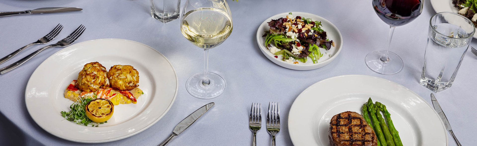 a plate of salad and a glass of wine