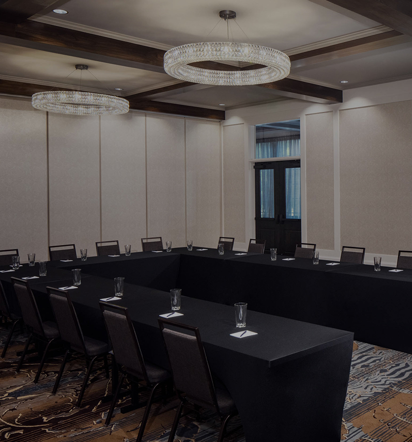a room with a long table and chairs