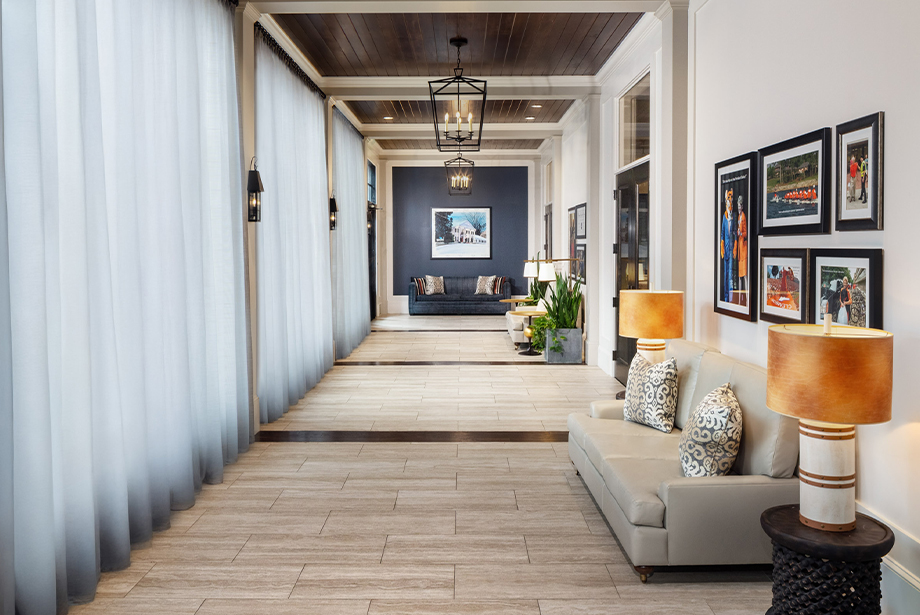 a long hallway with couches and lamps