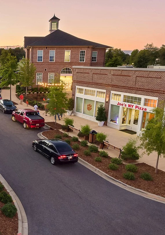 a building with a brick building and cars on the street