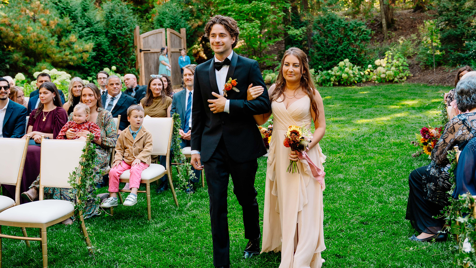 a man and woman walking down the aisle