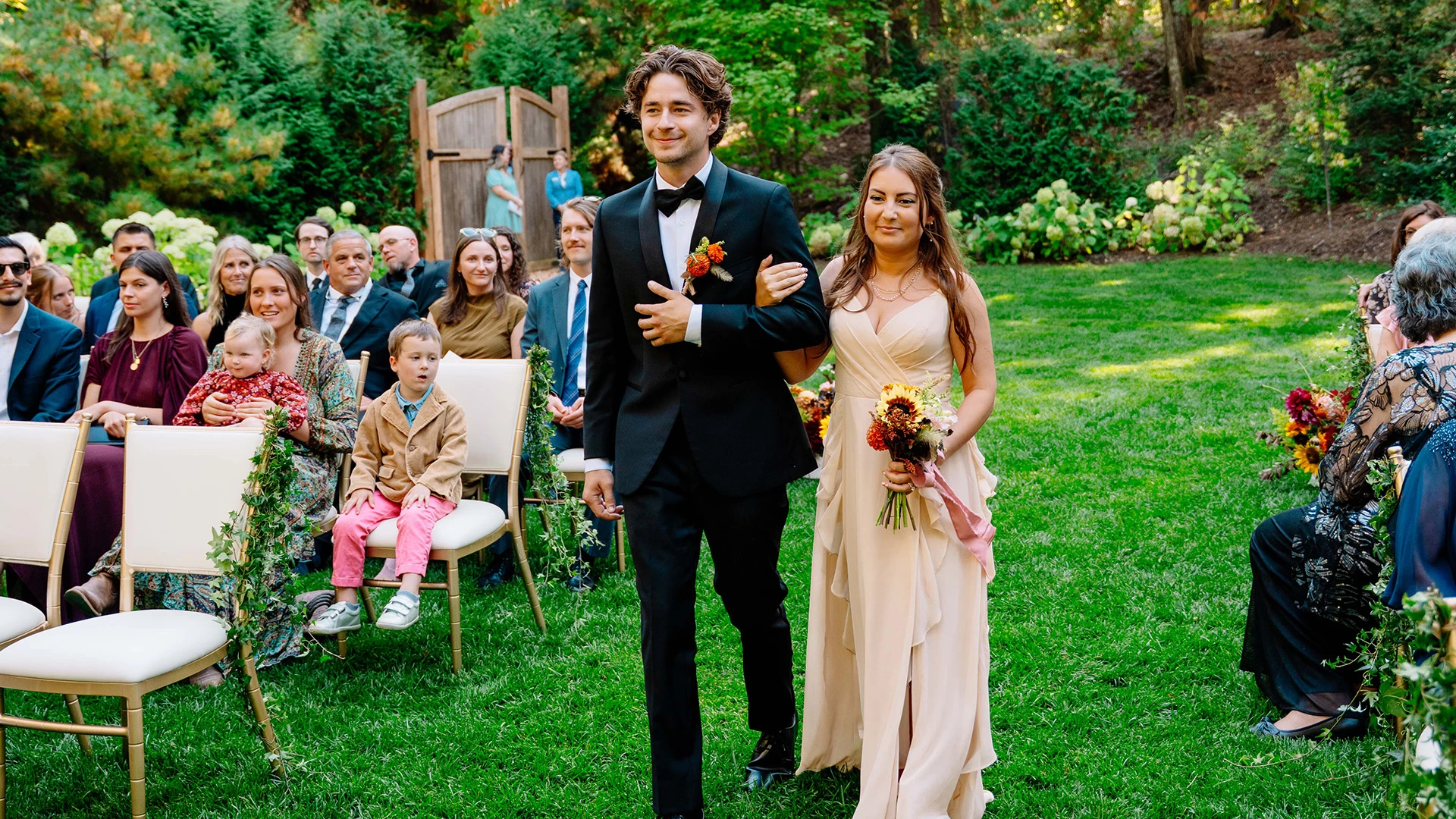 a man and woman walking down the aisle