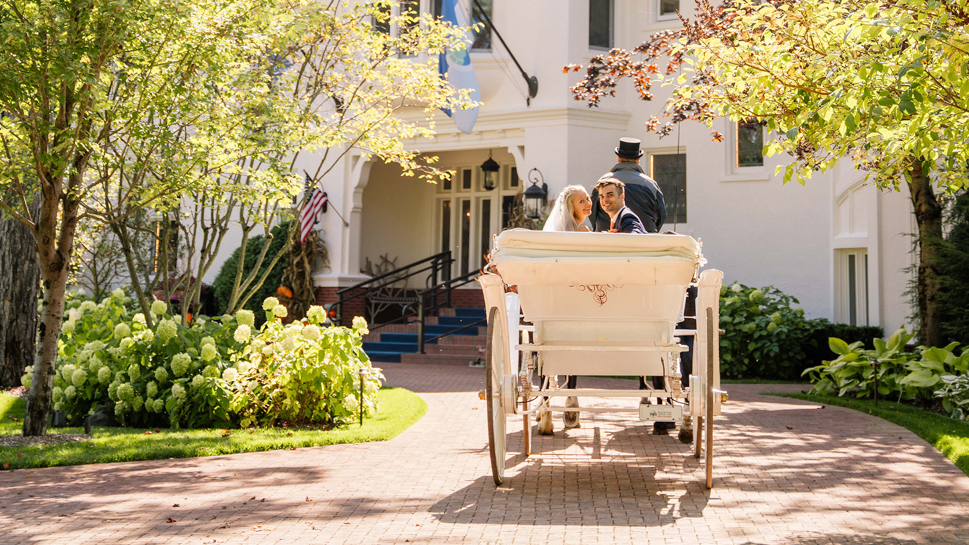 a man and woman in a white carriage