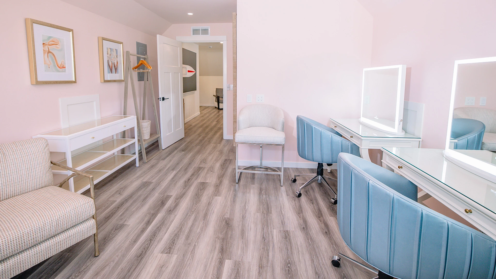 a room with a desk and chairs