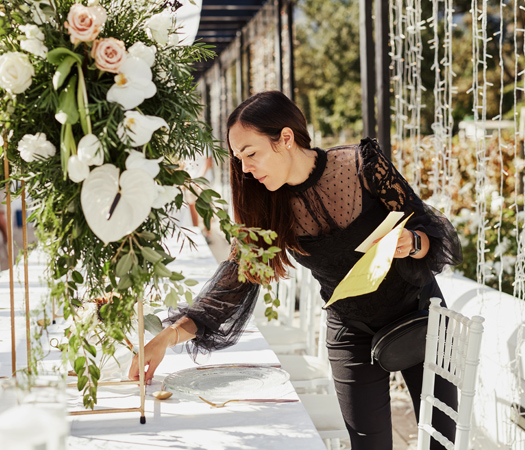 a woman writing on a table
