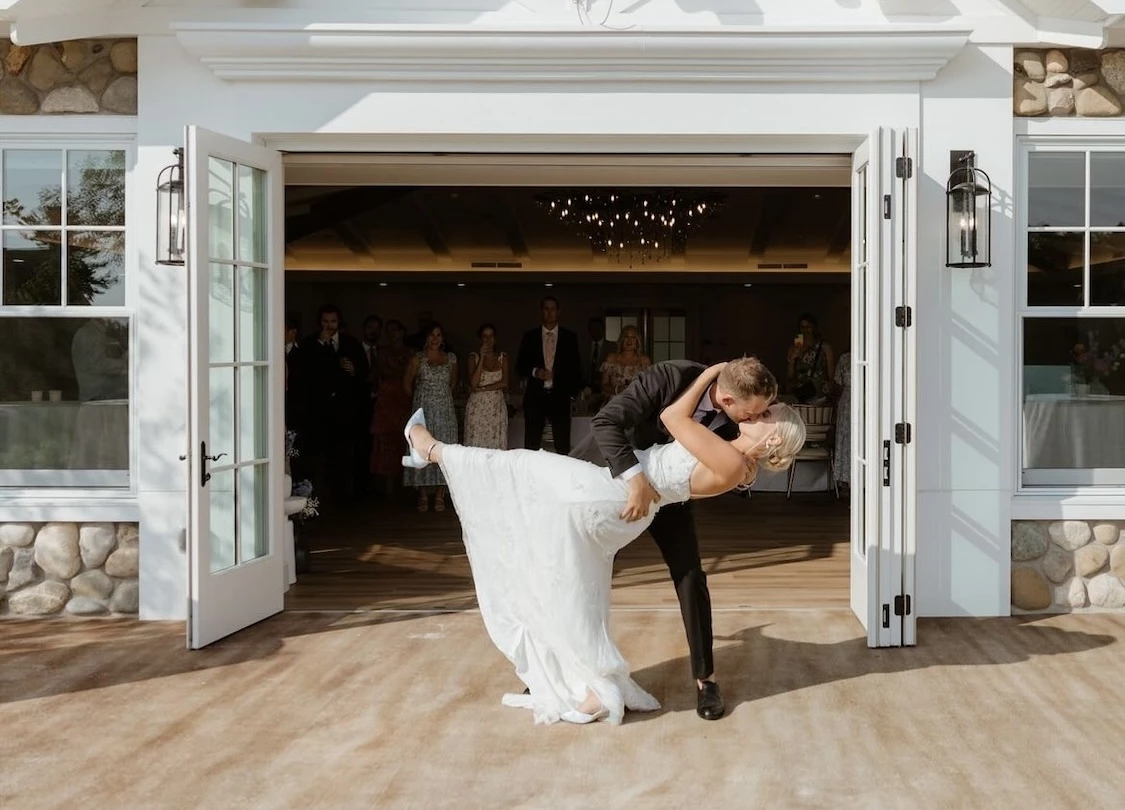 a man and woman kissing in front of a building