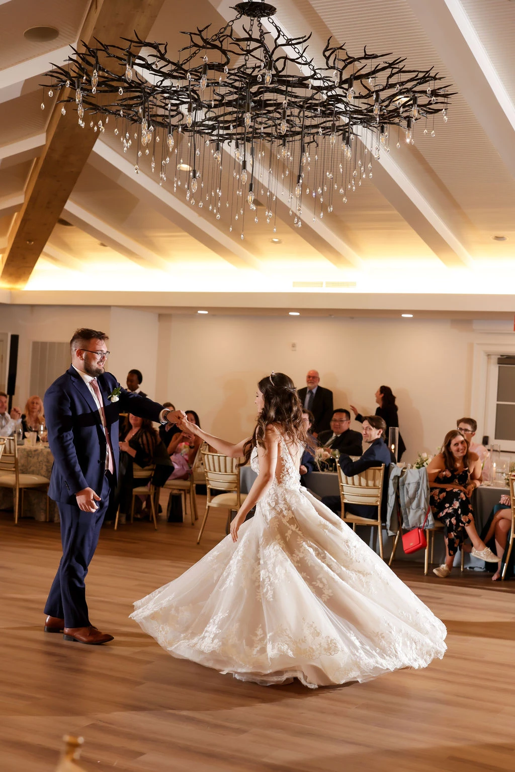 a man and woman dancing in a room with tables and chairs