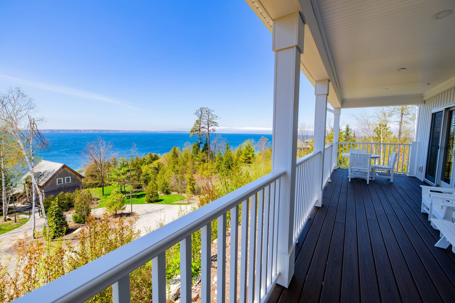 a deck with a view of the ocean and trees