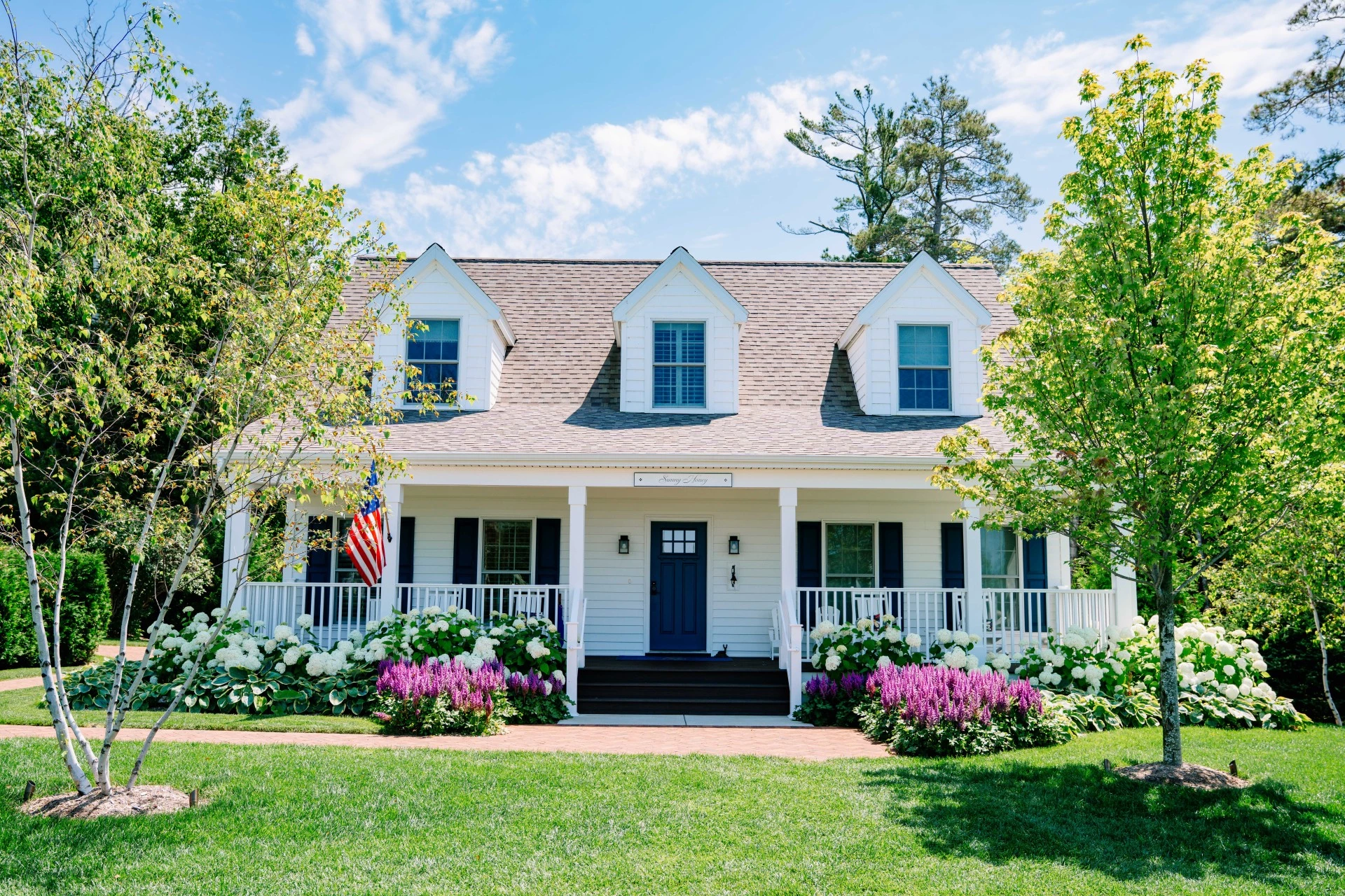 a house with a lawn and trees