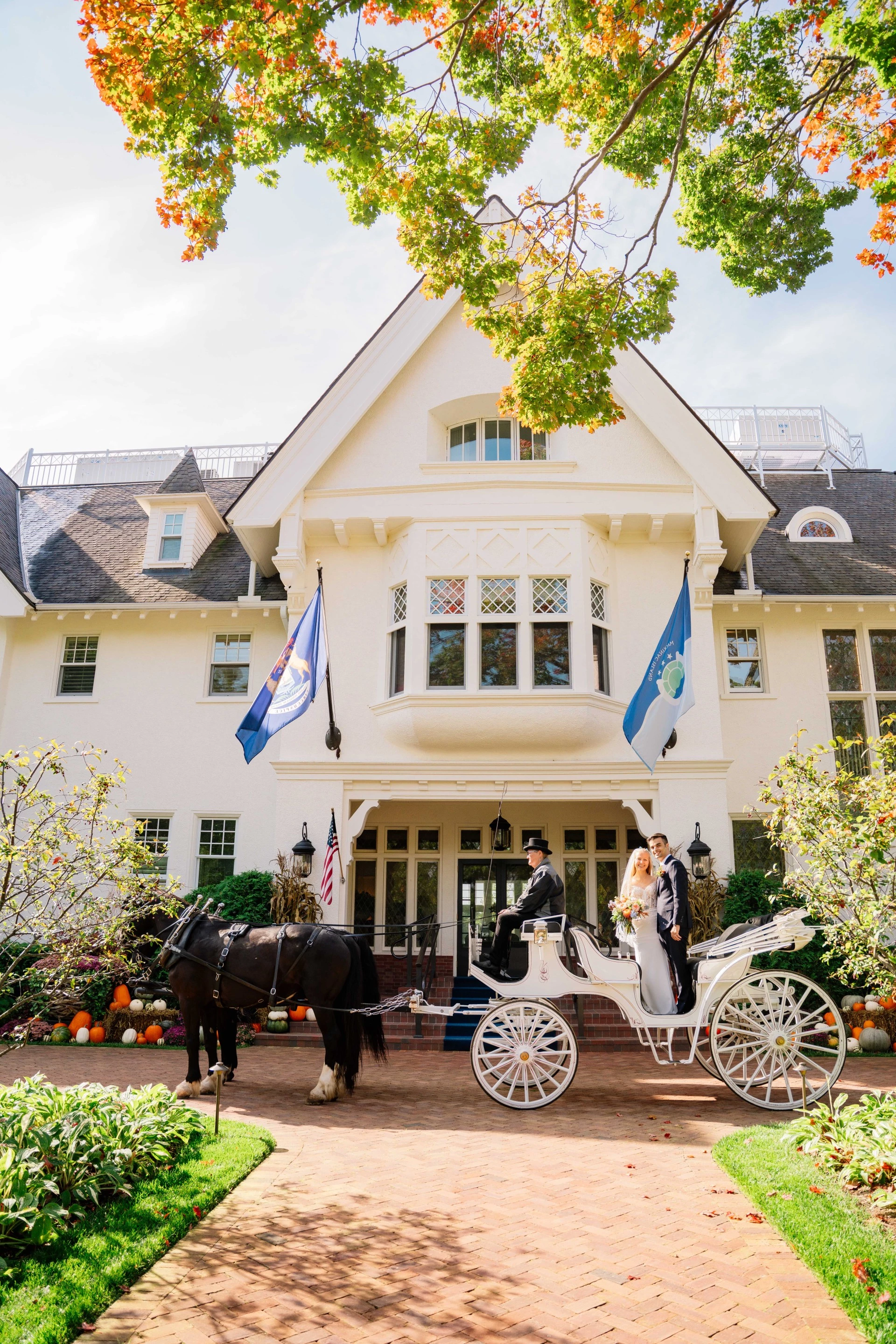 bride and groom on wedding carriage outside of Stonecliffe Mansion
