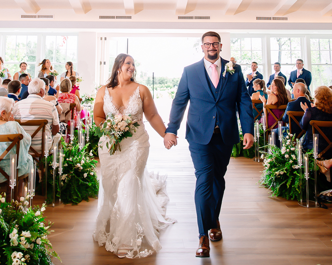 a man and woman walking down a aisle