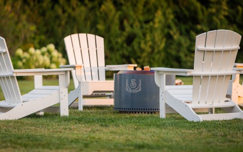 a group of chairs around a fire pit