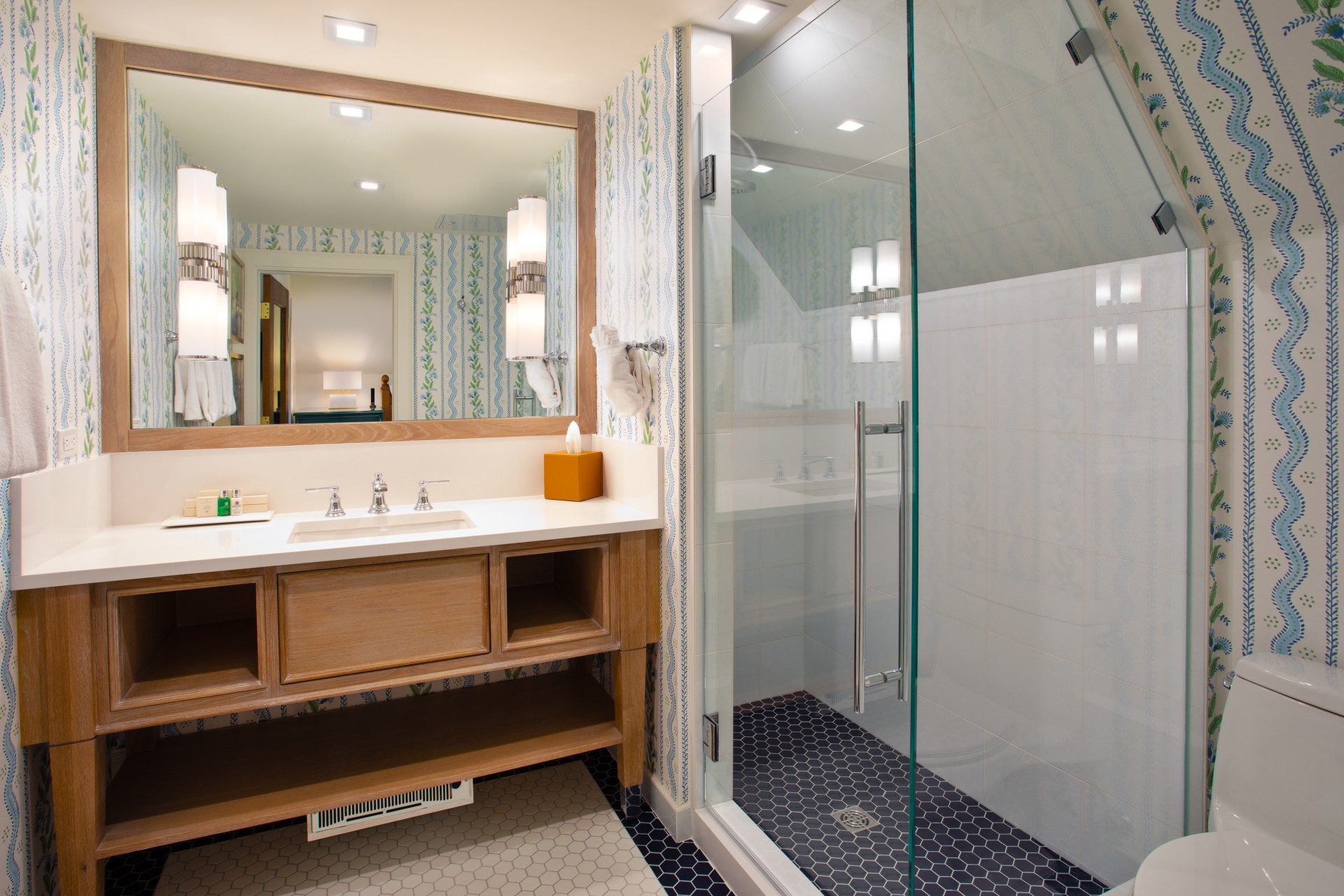 a bathroom with a glass shower and sink