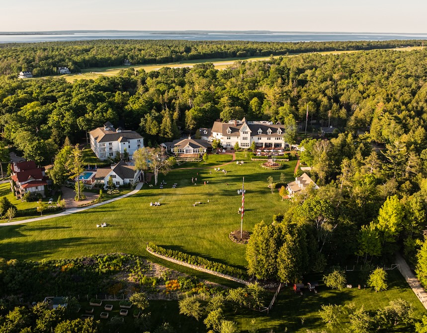 a large green lawn with buildings and trees