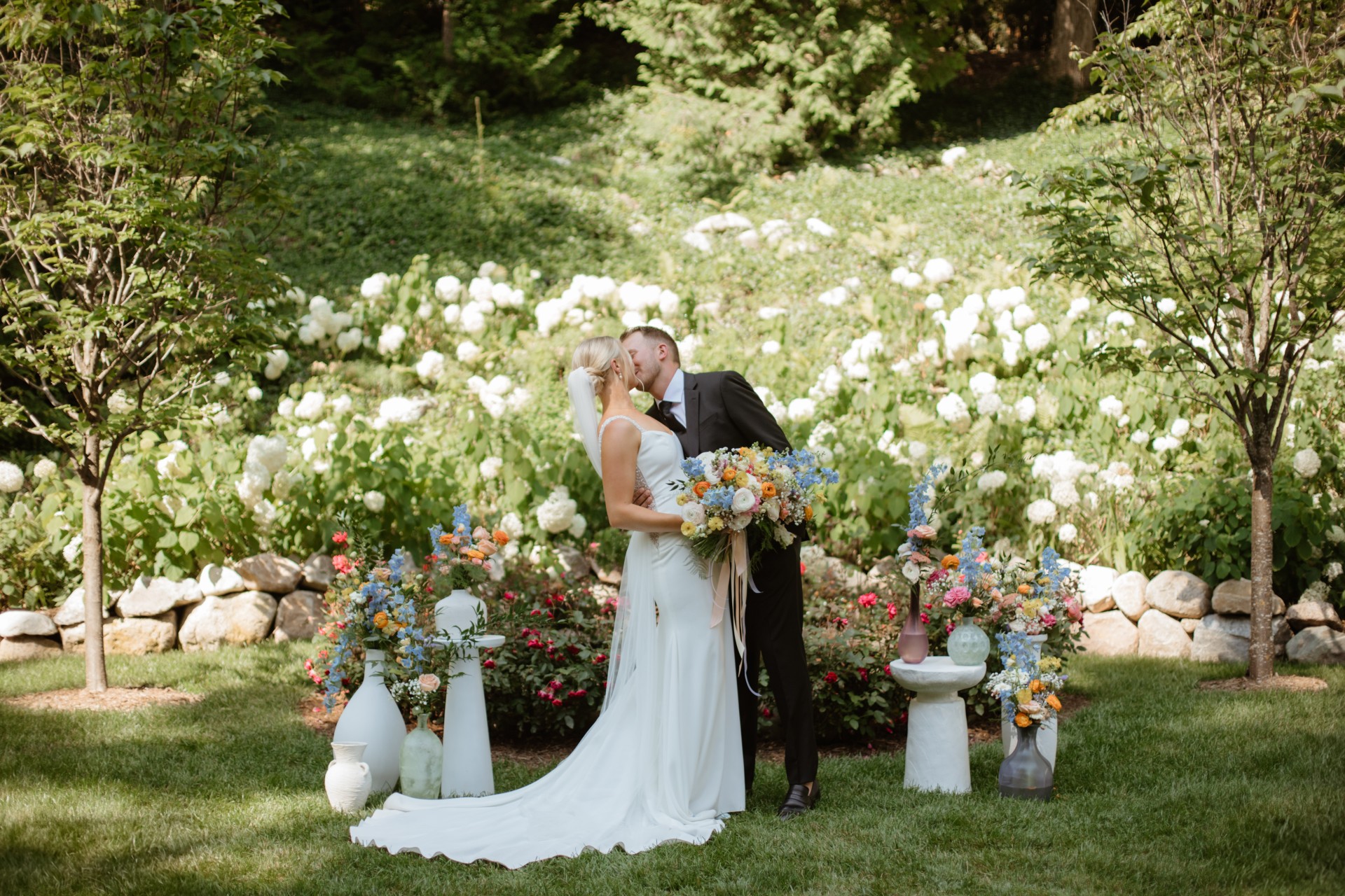 a man and woman kissing in a garden