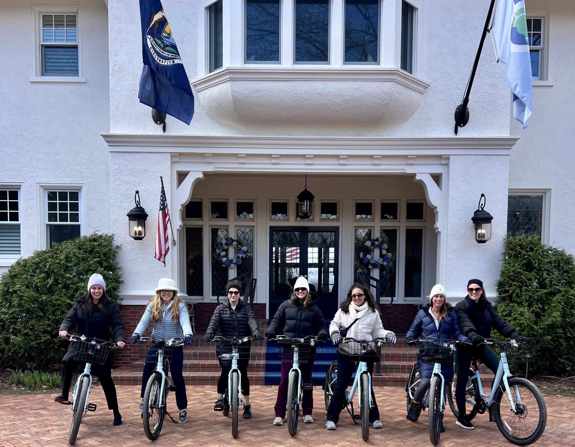 a group of people on bicycles in front of a building