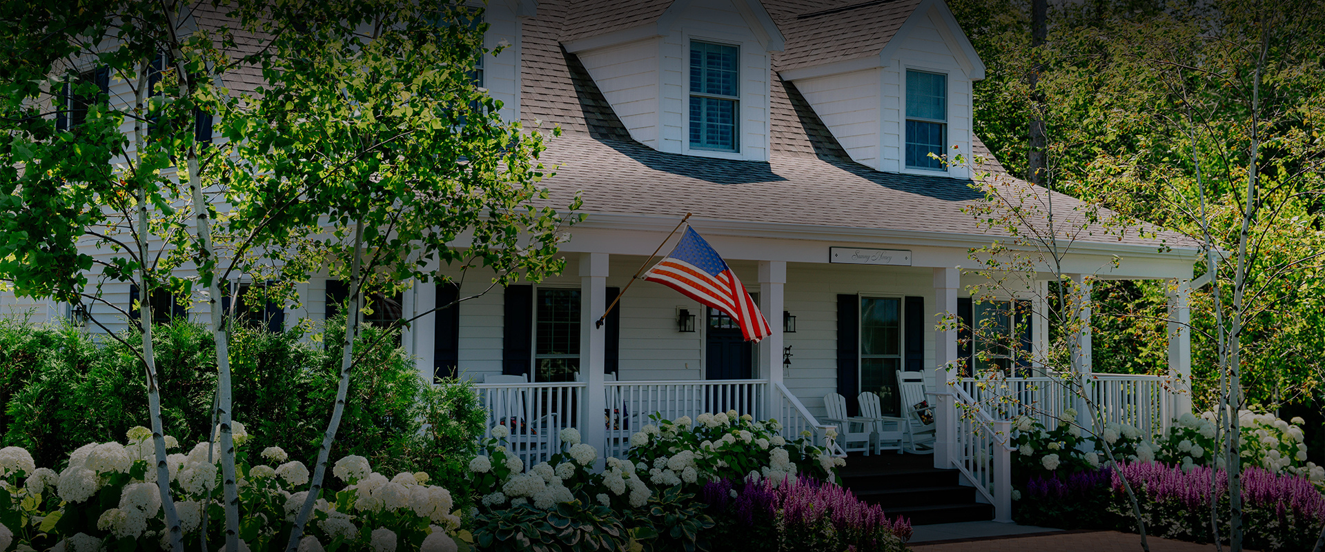 a flag on a flagpole in front of a house