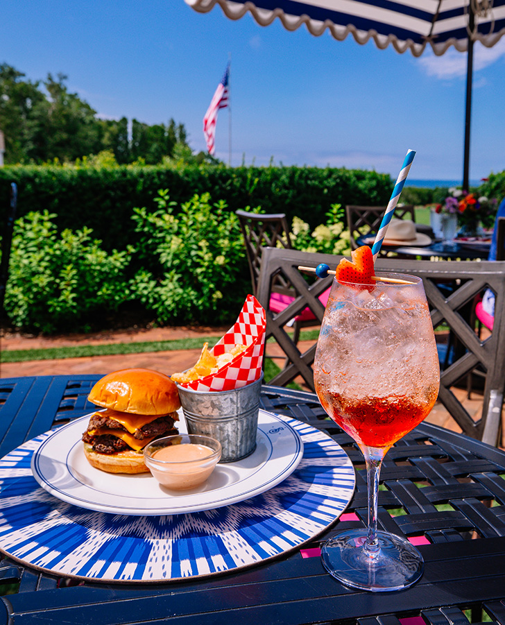 a burger and a drink on a table