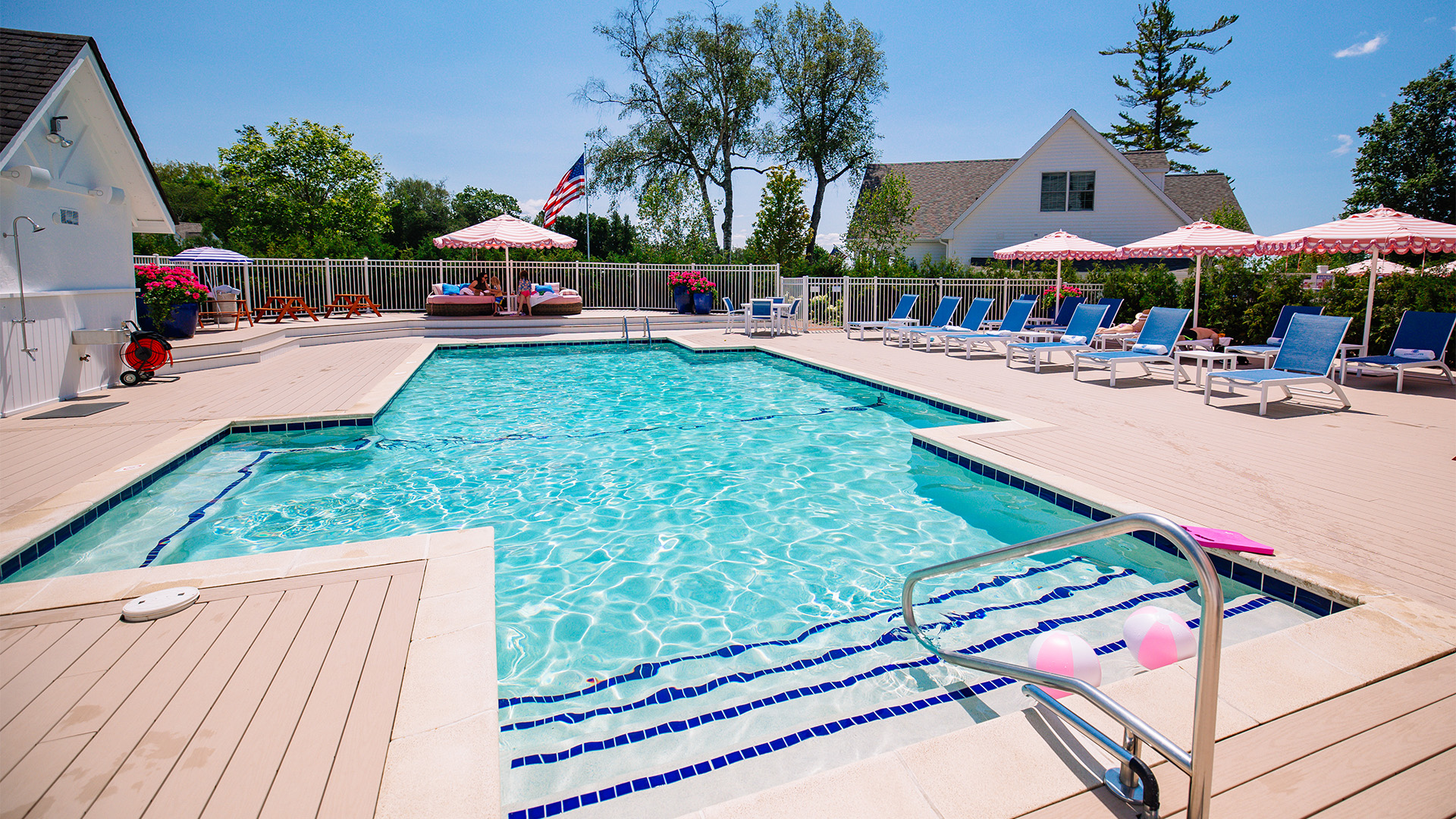 a pool with chairs and umbrellas
