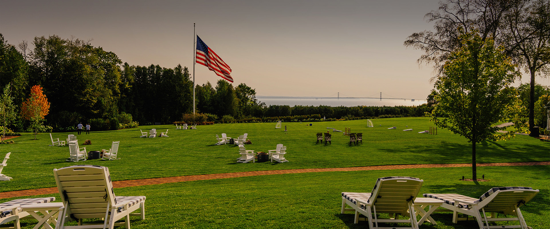 a lawn with chairs and a flag on it