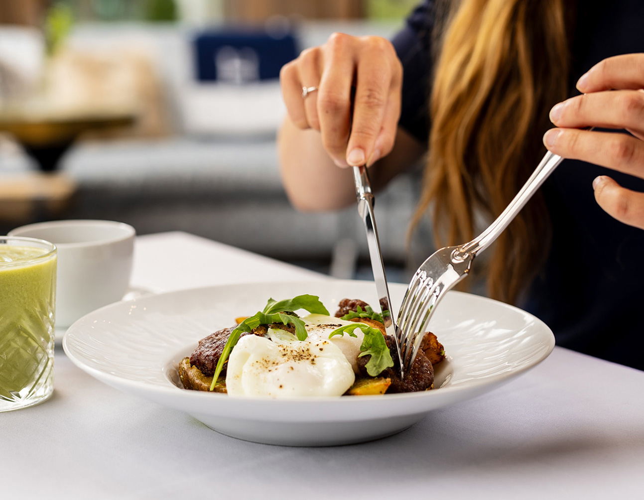 a person eating food with fork and knife