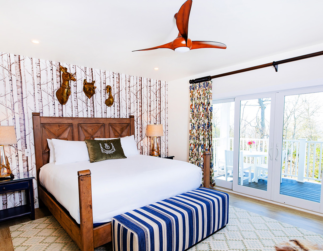 a bed in a room with a fan and a window