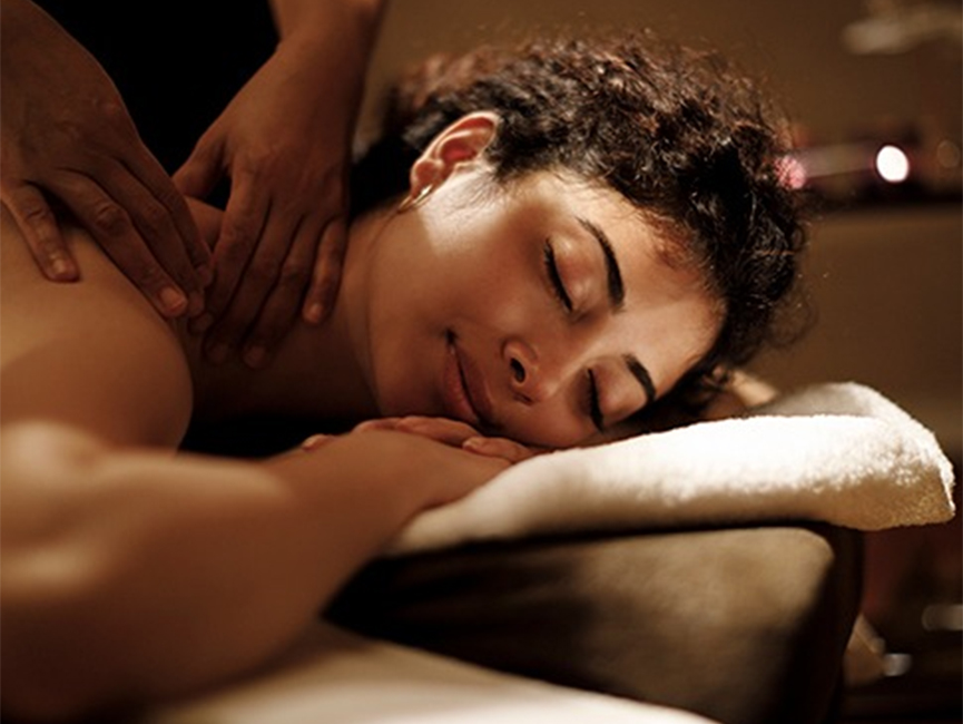 a woman lying down on a massage table