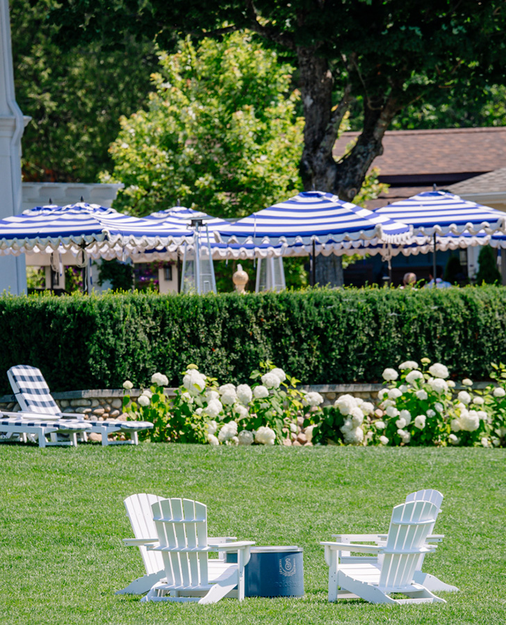 lawn with chairs and umbrellas in the background