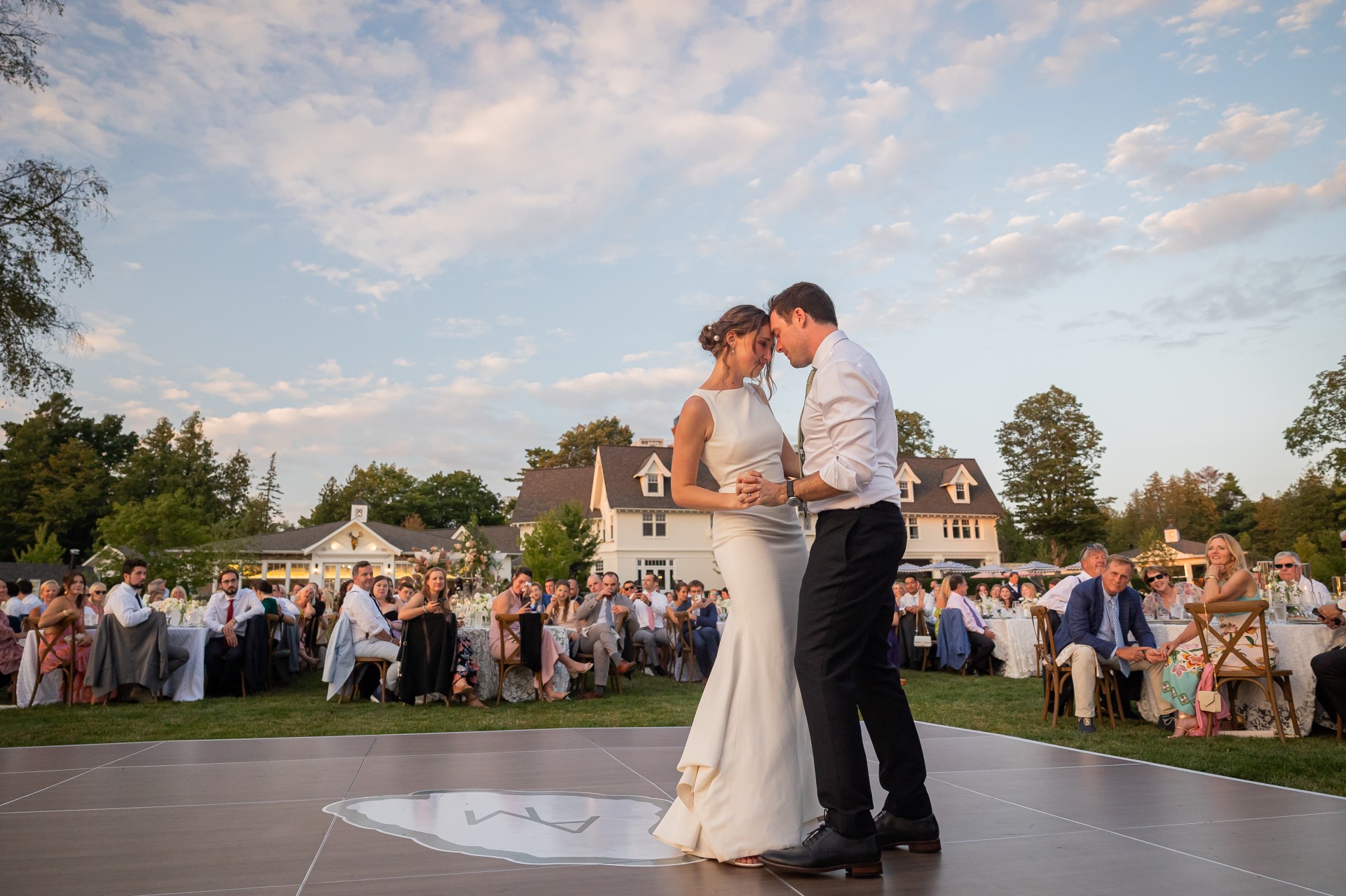 Outdoor wedding ceremony at The Inn at Stonecliffe on Mackinac Island overlooking the Straits of Mackinac and Mackinac Bridge, showing a scenic lawn venue ideal for summer and fall Mackinac Island weddings.