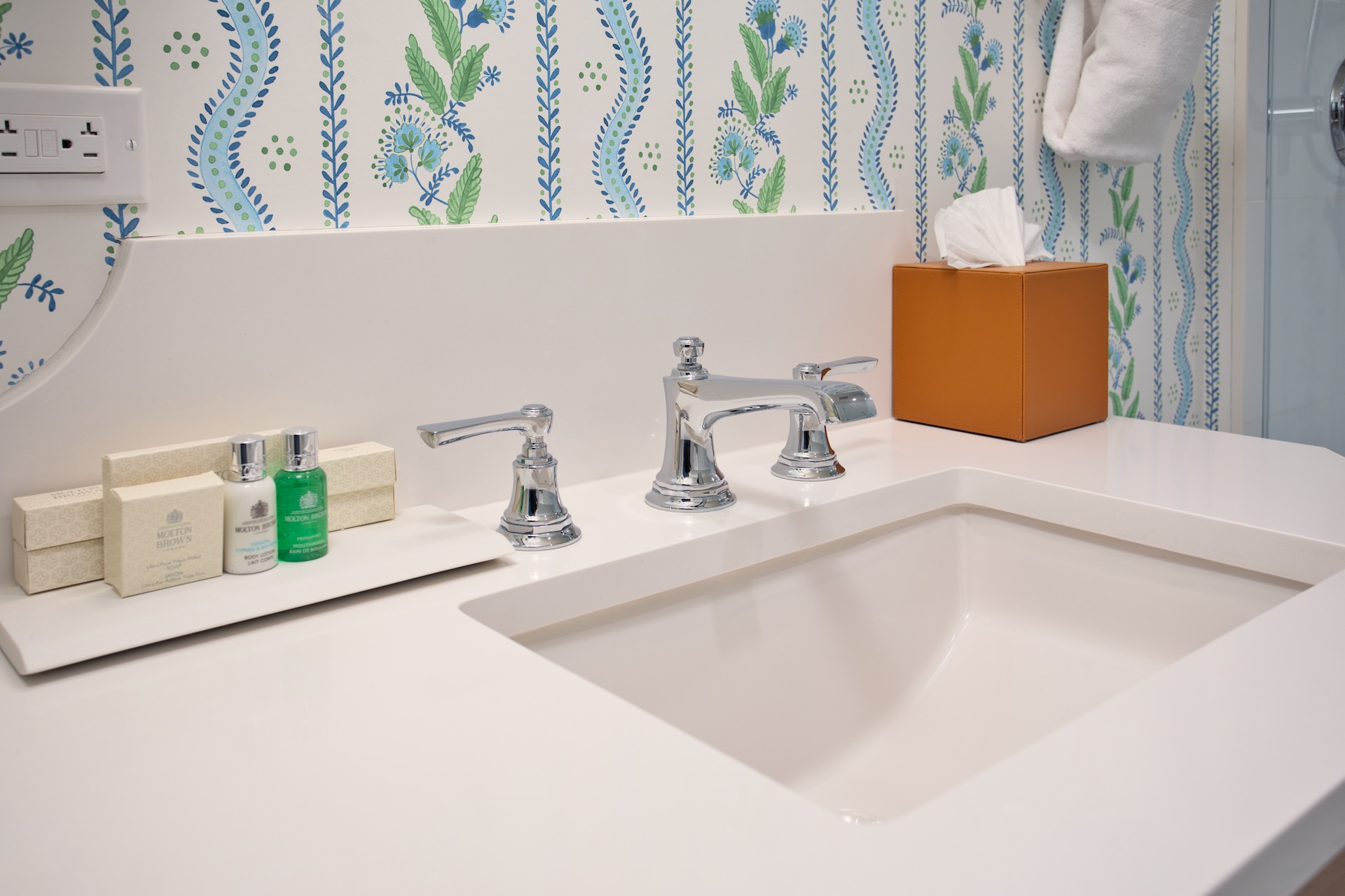a bathroom sink with a box of tissues