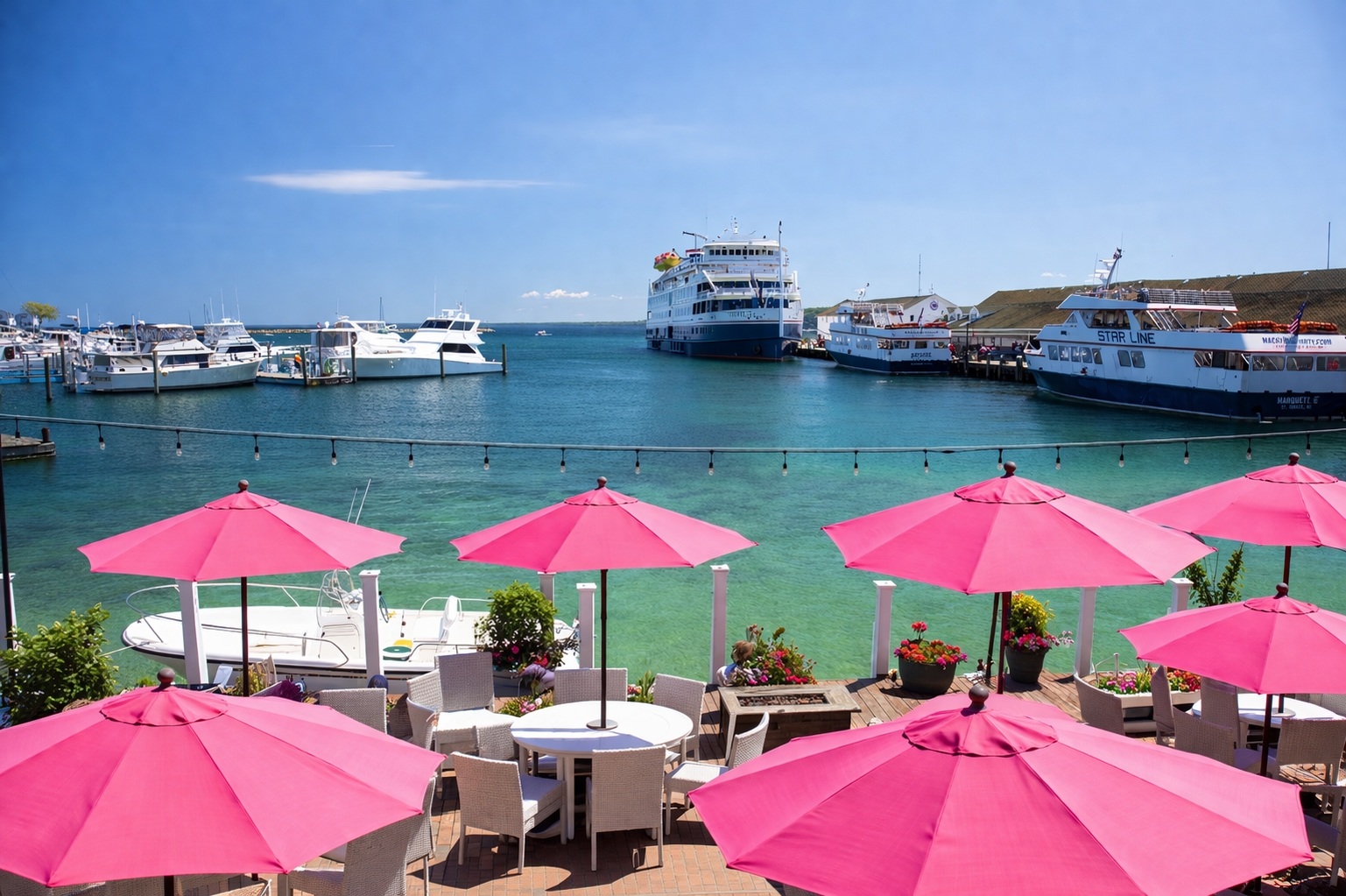 Pink Pony Mackinac Island waterfront patio with pink umbrellas and lake views