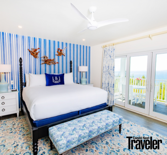 a bedroom with a bed and a blue striped wallpaper
