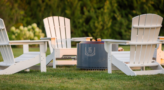 a white chairs and a fire pit