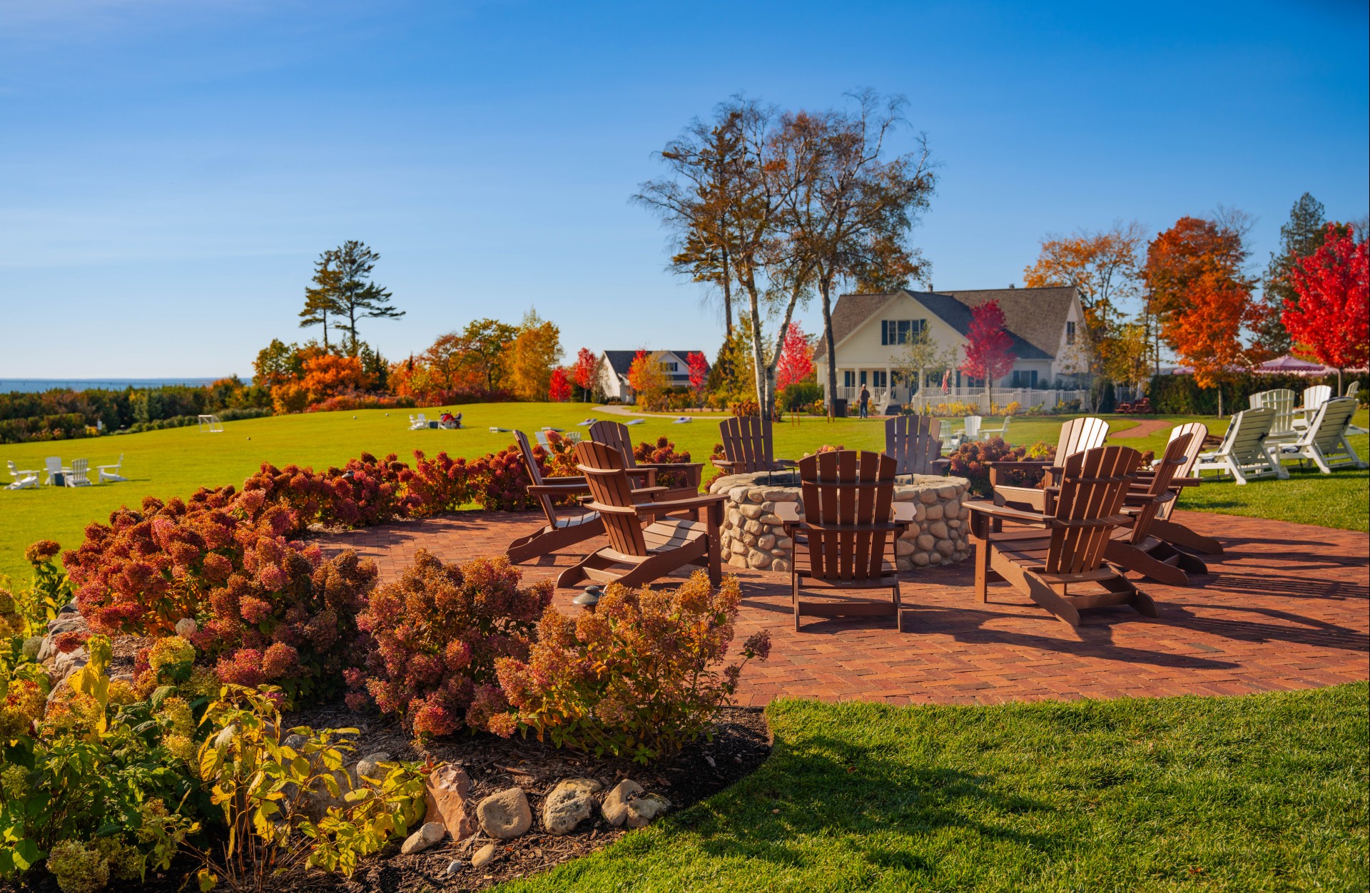 a patio with chairs around a fire pit