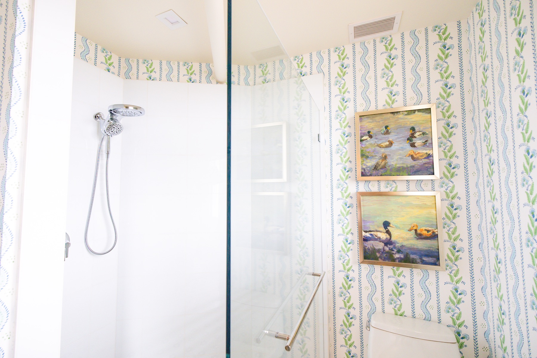 a shower with a glass door and a shower head