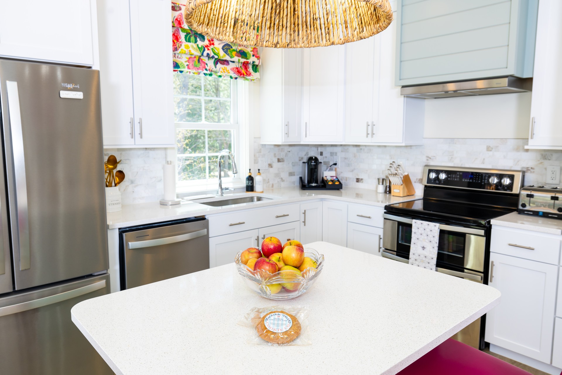 Sunny Honey Cottage kitchen with full-size appliances, white cabinetry, and colorful accents at The Inn at Stonecliffe on Mackinac Island
