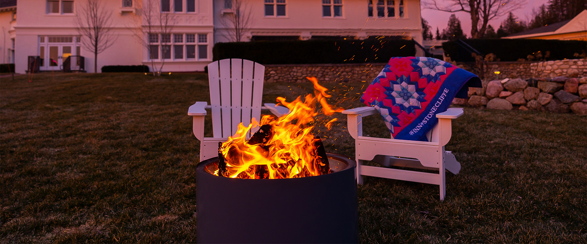 a fire pit in front of a white chair