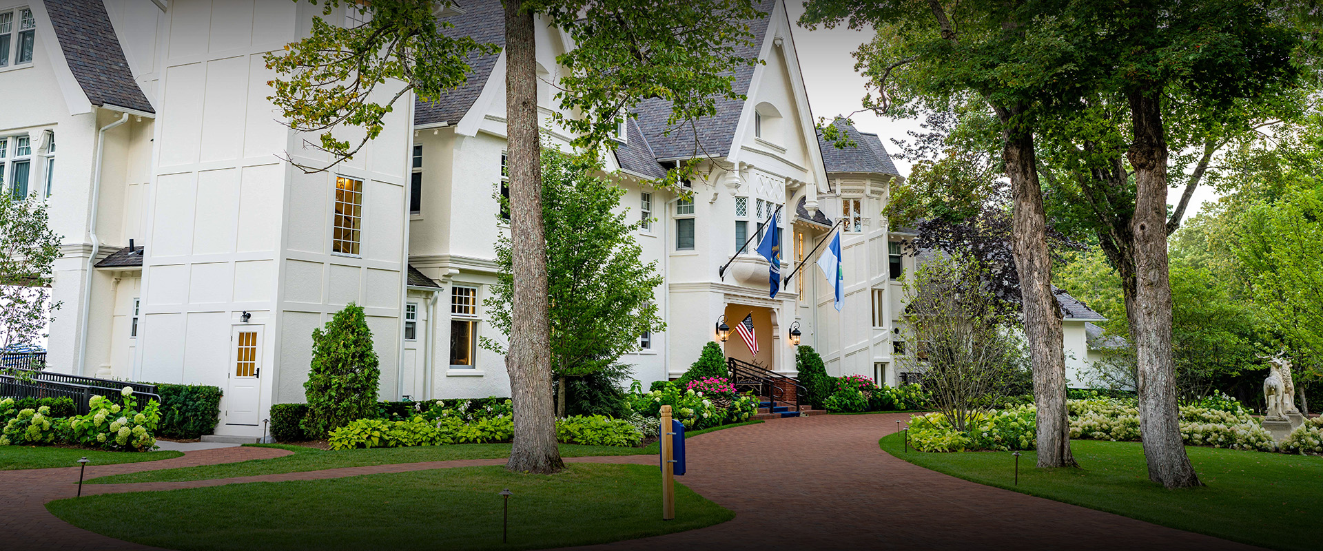 a white house with flags and trees