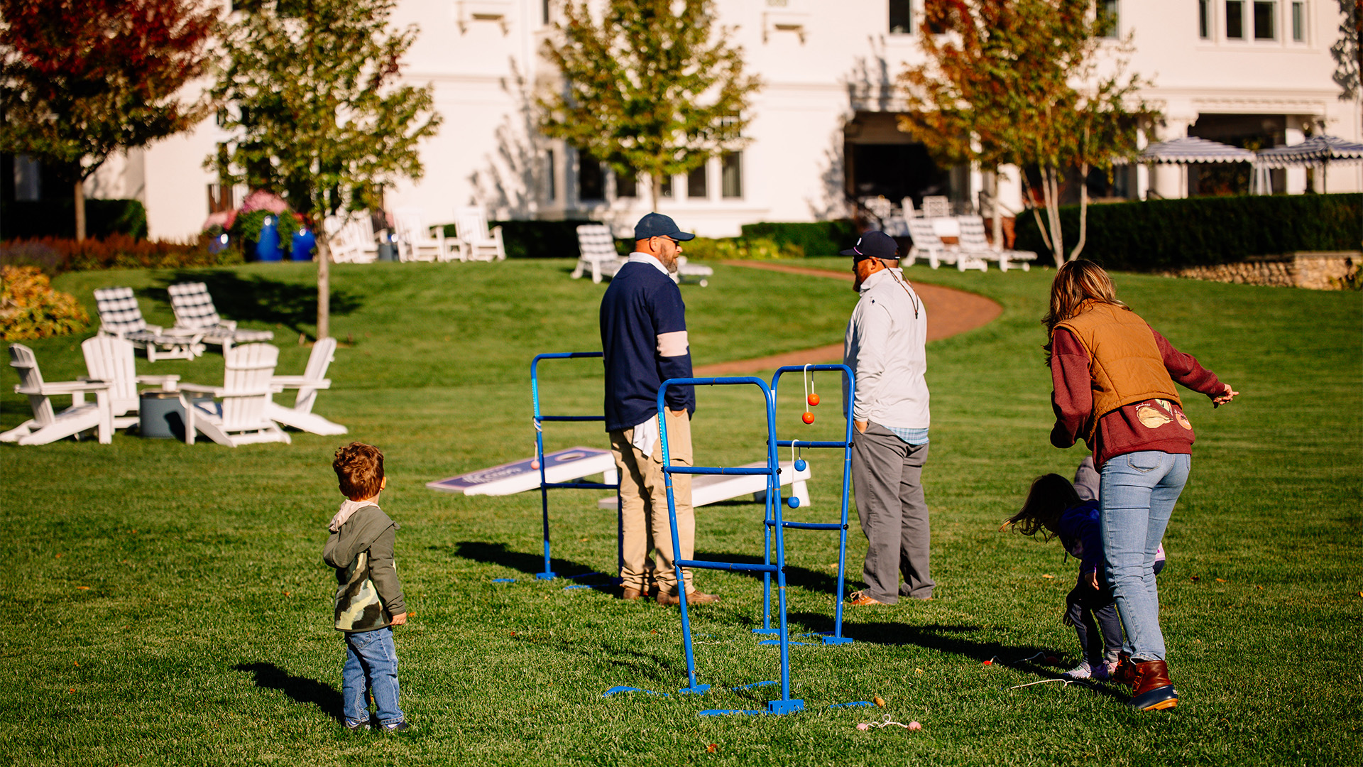 a group of people standing in a grassy area
