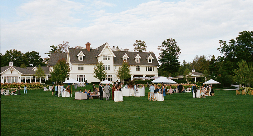 a group of people outside a house