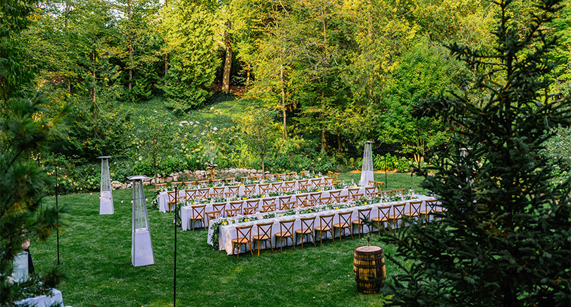 a long table set up in a garden