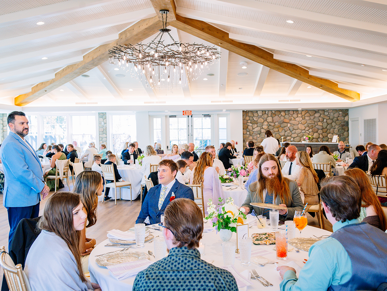 a group of people sitting at tables in a room with tables and chairs
