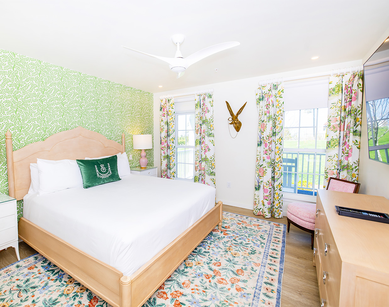 Garden-view guest room with floral curtains at The Inn at Stonecliffe, one of the serene Mackinac Island hotels.