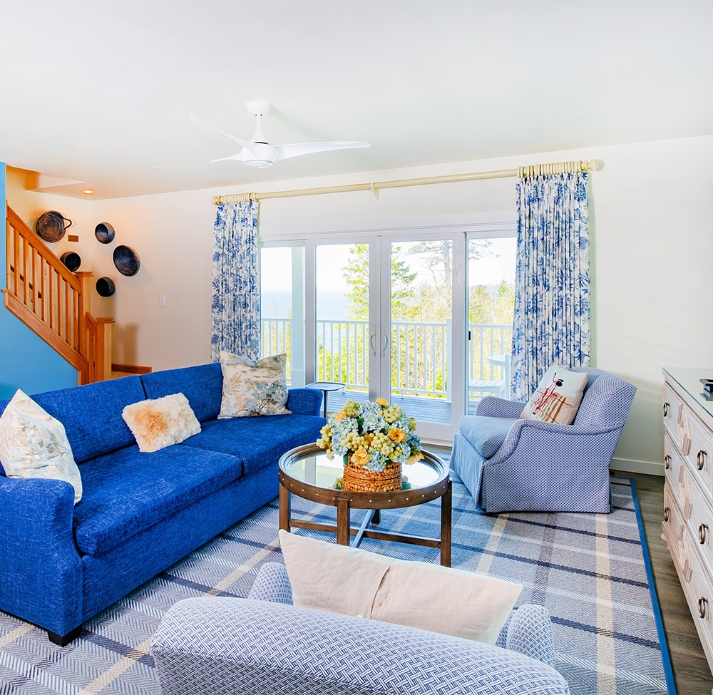 a living room with blue couches and a blue and white couch