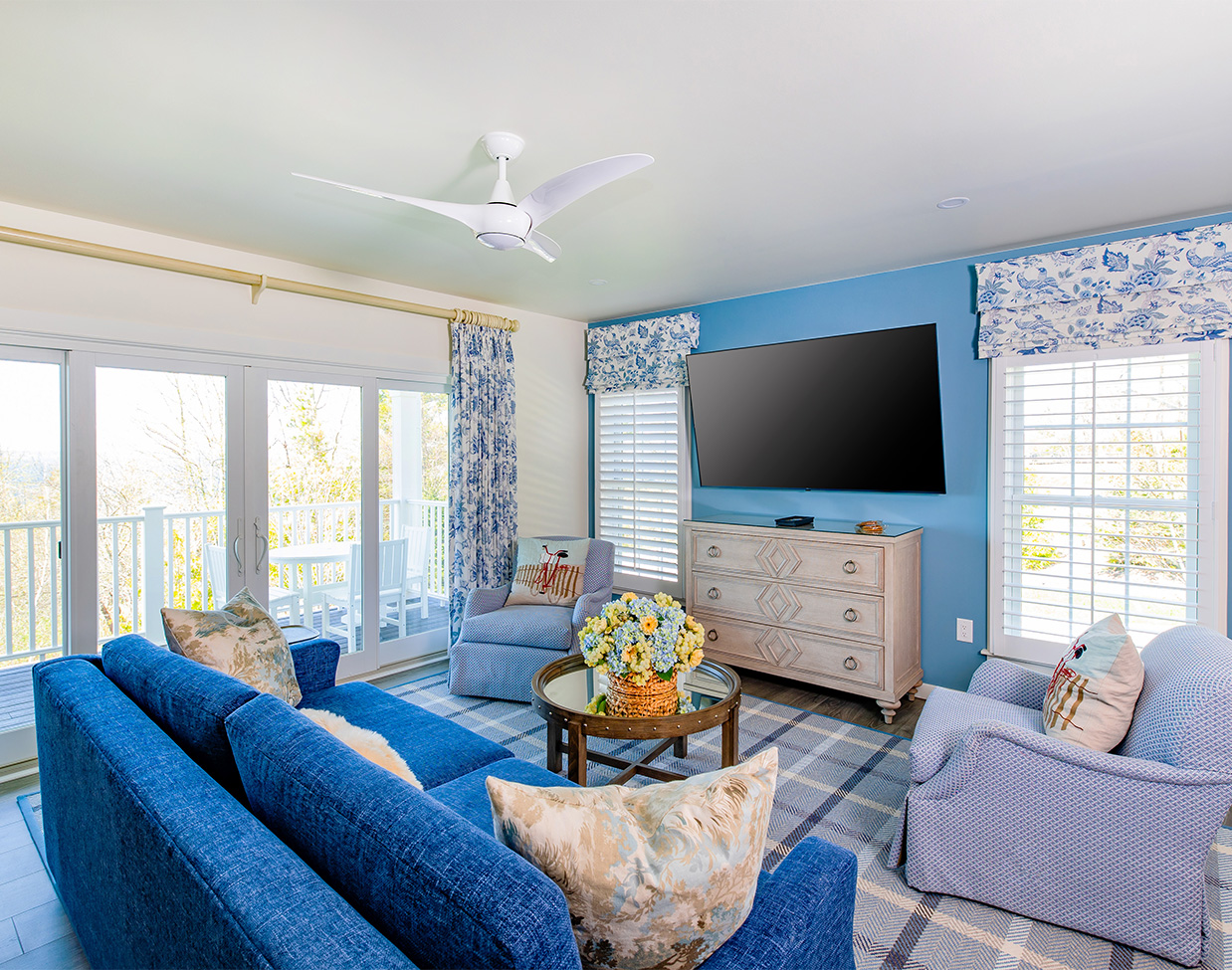 Blue-accented suite lounge with balcony access at The Inn at Stonecliffe, one of the scenic Mackinac Island hotels.